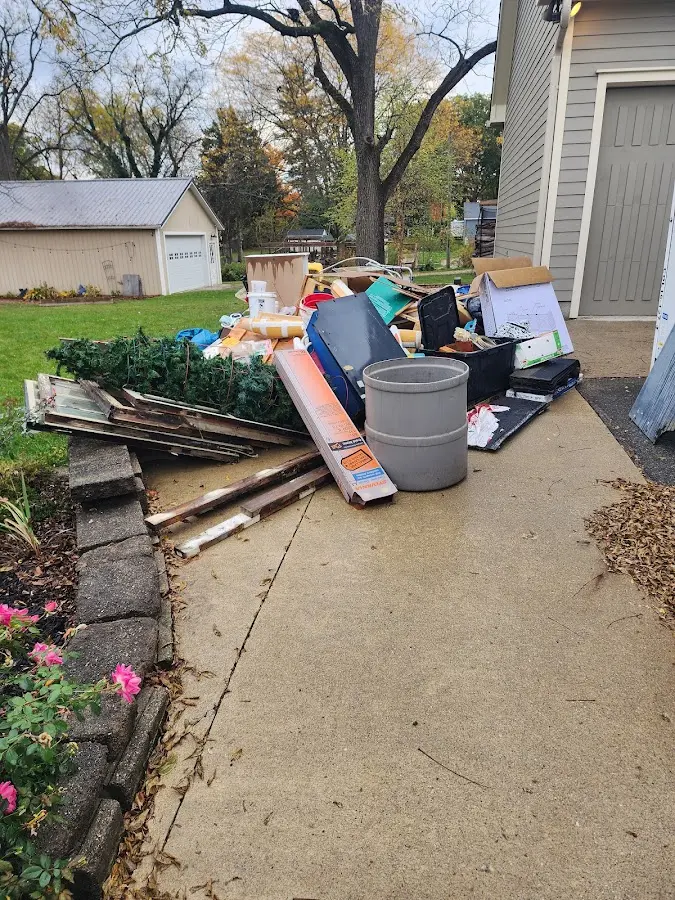 Dumpster being loaded with debris for 10 Yard Dumpster Rental in Tallulah